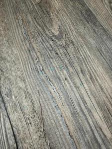 a close up of a wooden floor with some dirt at PEN Smart Hotel in Türkheim