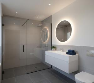 a bathroom with a white sink and a shower at Hotel Clina in Adana