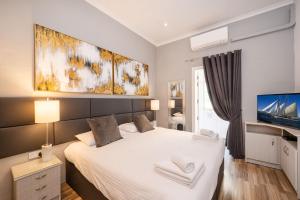 a bedroom with a bed and a television in it at Valletta Apartments 19 in Valletta