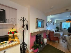 a living room with a fireplace and a living room at Half Pint Cottage in Uplyme