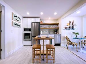 a kitchen with a table and chairs and a refrigerator at Paradise Cove at Island Getaway in Bradenton Beach +20 photos