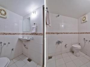 a bathroom with a shower and a toilet and a sink at Hotel O Milan Party Hall in Vadodara +76 photos