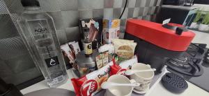 a counter top with a coffee maker and some food at La Dolce Casa & City Center I Balcony I Netflix in Bucharest