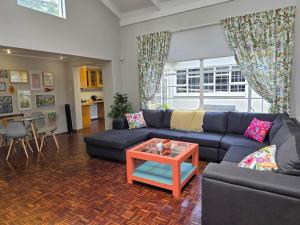 a living room with a blue couch and a table at Grazia in King in Harrismith