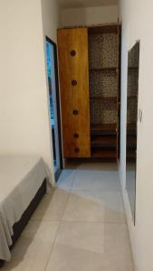 a room with a closet and a bed and a door at Casa a 100 metros da praia do Jabaquara in Paraty