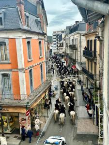 a herd of animals walking down a city street at A l'ombre de la Tour in Lourdes