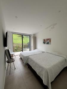 Giường trong phòng chung tại Casa Campestre con Piscina