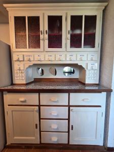 a kitchen with white cabinets and a counter top at Casa Leyian - Free parking in Brissago