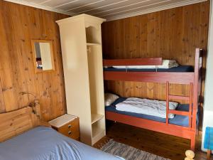 a room with three bunk beds in a cabin at Skåbu Camping in Skåbu