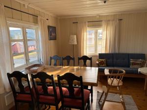 a living room with a table and a couch at Skåbu Camping in Skåbu