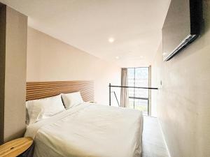 a bedroom with a white bed and a window at Flat 119 in Bogotá