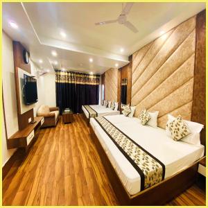 Una habitación de hotel con dos camas y un televisor. en SEA VIEW from rooftop HOTE S NIWAS ! PURI near Swargadwar - Golden Beach - Jagannath Temple - Parking - Fully Air Conditioning Rooms - BEST HOTEL IN PURI, en Puri