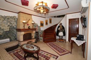 a living room with a fireplace and a staircase at Hotel Boutique Ergjeria in Gjirokastër