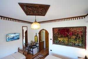 a living room with a tapestry hanging on the wall at Hotel Boutique Ergjeria in Gjirokastër