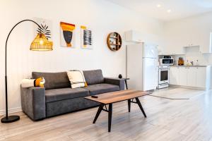 a living room with a couch and a table at AFRICA - SelfCheckIn - Plateau - St-Laurent in Montréal