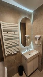 a bathroom with a sink and a mirror at Apartament z widokiem na panoramę Tatr "AppWidokowa9" in Gliczarów Górny +19 photos