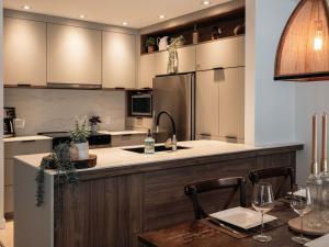 una cocina con una mesa y un refrigerador en Mountain Escape Ski-In Ski-Out Laurentians, en Saint-Faustin