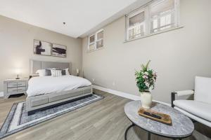 a bedroom with a bed and a couch and a table at Chic Studio Retreat in New Haven in New Haven
