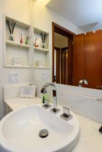 a bathroom with a sink and a mirror at Flat Maravilhoso Copacabana (BestHostRio) in Rio de Janeiro
