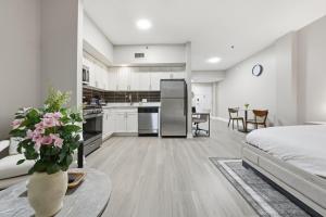 a kitchen and living room with a bed and a table at Chic Studio Retreat in New Haven in New Haven