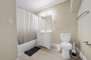 a bathroom with a toilet and a sink and a shower at Chic Studio Retreat in New Haven in New Haven +17 photos