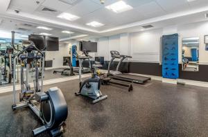 a gym with several treadmills and cardio machines at Relaxing studio perfect for extended visits in New Haven