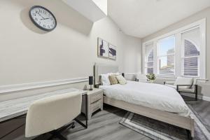 a bedroom with a bed and a clock on the wall at Homey studio perfect for long-term guests in New Haven