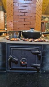 a stove with a pan on top of it at SIG - Rancho Desiam - Serra Gaúcha in Gramado +22 photos