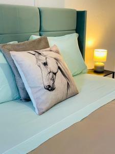 a bed with a pillow with a picture of a cow at Janelas do Governador in Elvas