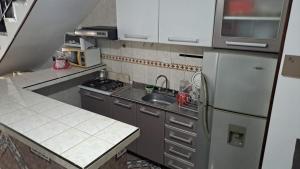 a small kitchen with a refrigerator and a sink at samargo in Cali