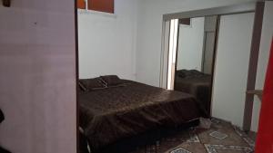 a bedroom with a bed and a mirror at samargo in Cali