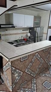 a kitchen with a counter with a sink and a stove at samargo in Cali