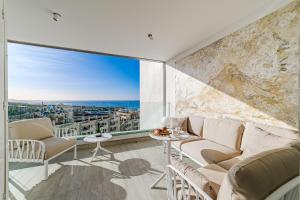 a living room with a view of the ocean at Sundream Escape - Penthouse with ocean view, airco, heated pool in Adeje