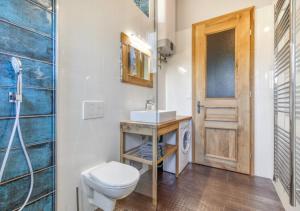 a bathroom with a toilet and a sink at Resort Papírna50 in Černý Dŭl +40 photos