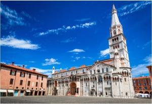 a large building with a tower on top of it at RELAIS SUITE Modena Parc in Modena
