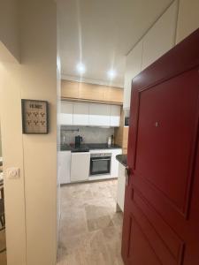 een keuken met een rode deur in een kamer bij Cosy Hoche Saint Gervais in Pré Saint Gervais +14 foto's