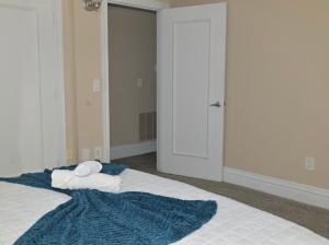 a bedroom with a bed with towels on it at The Cozy Luxe Retreat, Central West End in Saint Louis