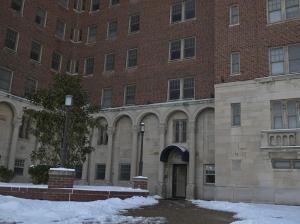 a large brick building with a door in front of it at The Cozy Luxe Retreat, Central West End in Saint Louis
