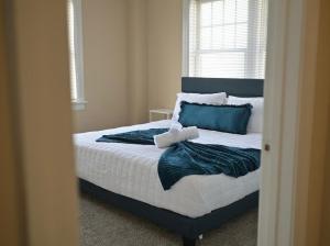 a bedroom with a large bed with a mirror at The Cozy Luxe Retreat, Central West End in Saint Louis +6 photos