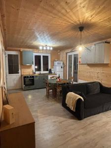 a living room with a couch and a table at Lodge des Mélèzes in Ancelle
