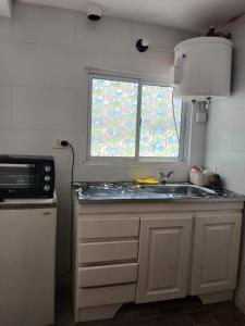 a kitchen with a sink and a window at MyM in Merlo