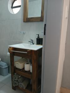 a bathroom with a sink and a mirror at MyM in Merlo