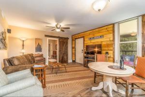 a living room with a couch and a table at All Aboard Stylish Downtown Loft, Walk to Restaurants, Shops, Train in Bryson City
