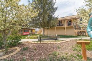 a park bench in front of a building at All Aboard Stylish Downtown Loft, Walk to Restaurants, Shops, Train in Bryson City +24 photos