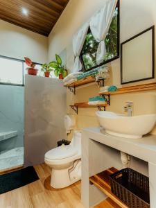 a bathroom with a toilet and a sink at Cabañas Caeli, El Colibri, NEW La Fortuna Rainforest Cabin w Panoramic Views in San Francisco