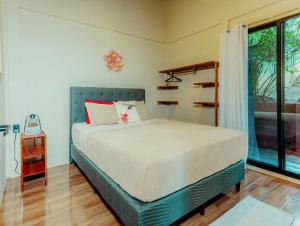 a bedroom with a bed and a large window at Cabañas Caeli, El Colibri, NEW La Fortuna Rainforest Cabin w Panoramic Views in San Francisco +50 photos