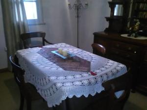 a table with a white table cloth and candles on it at bluebird cottage in Angaston