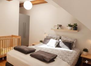 a bedroom with a bed with pillows on it at Domki apartamenty Nasza Chata - 4 minuty od plaży in Pobierowo