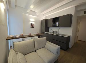 a living room with a couch and a kitchen at NALI Apartment 1 in Civitanova Marche