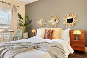 a bedroom with a bed with two mirrors on the wall at Kasa Gaslamp Quarter San Diego in San Diego
